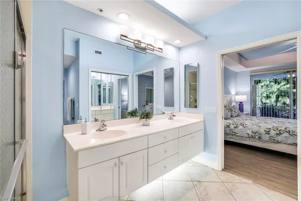 a bathroom with a sink double vanity and a mirror