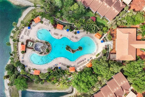 an aerial view of residential houses with outdoor space and swimming pool