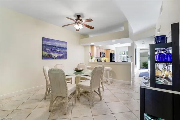a view of a dining room with furniture and a potted plant
