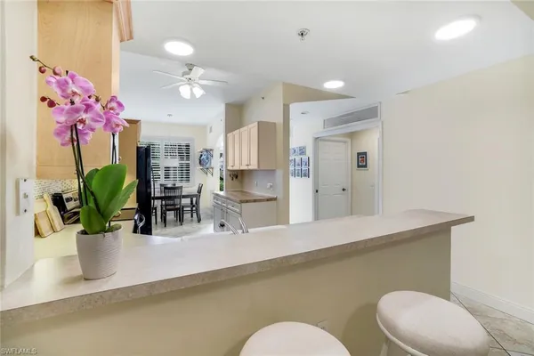 a dining room with furniture and chandelier fan