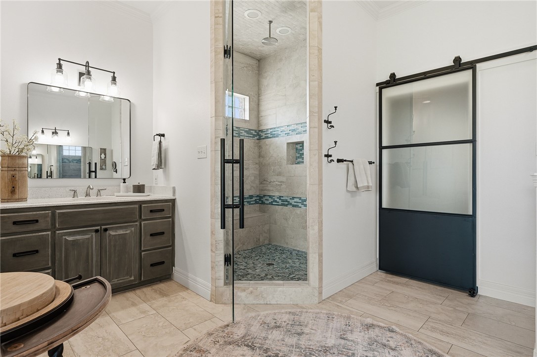 8710 KIng Ranch Drive Corpus Christi, TX 78414 - Photo 13 of 38 a bathroom with a double vanity sink a mirror and a shower