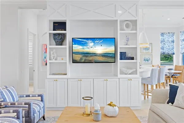 a bedroom with furniture and a flat screen tv