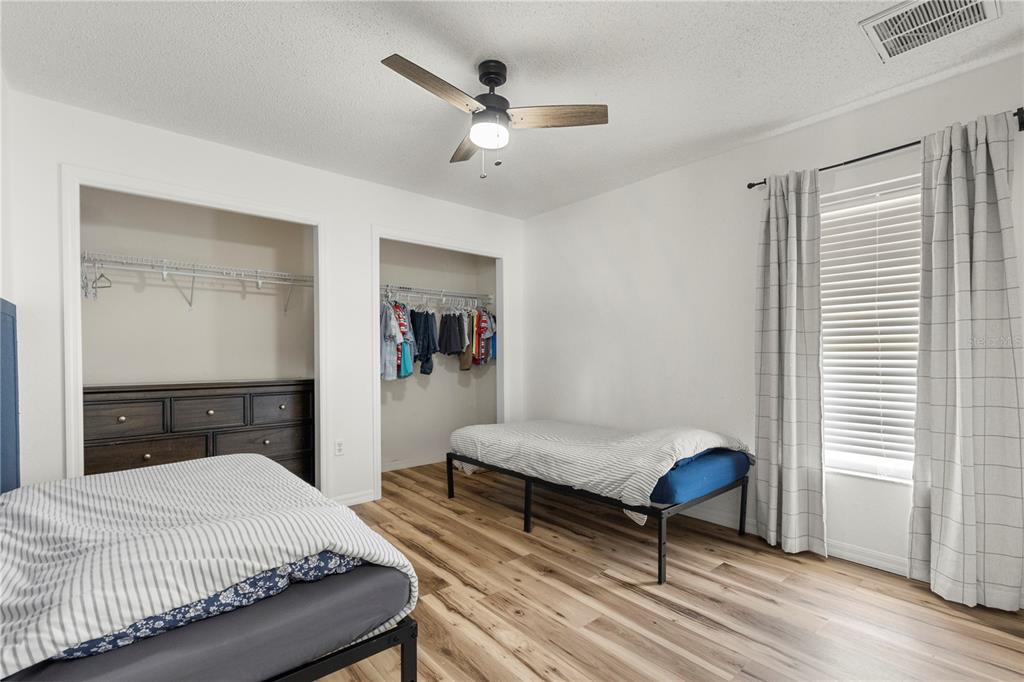9917 Nelson Road Dade City, FL 33525 - Photo 32 of 40 a bedroom with a bed and a chandelier