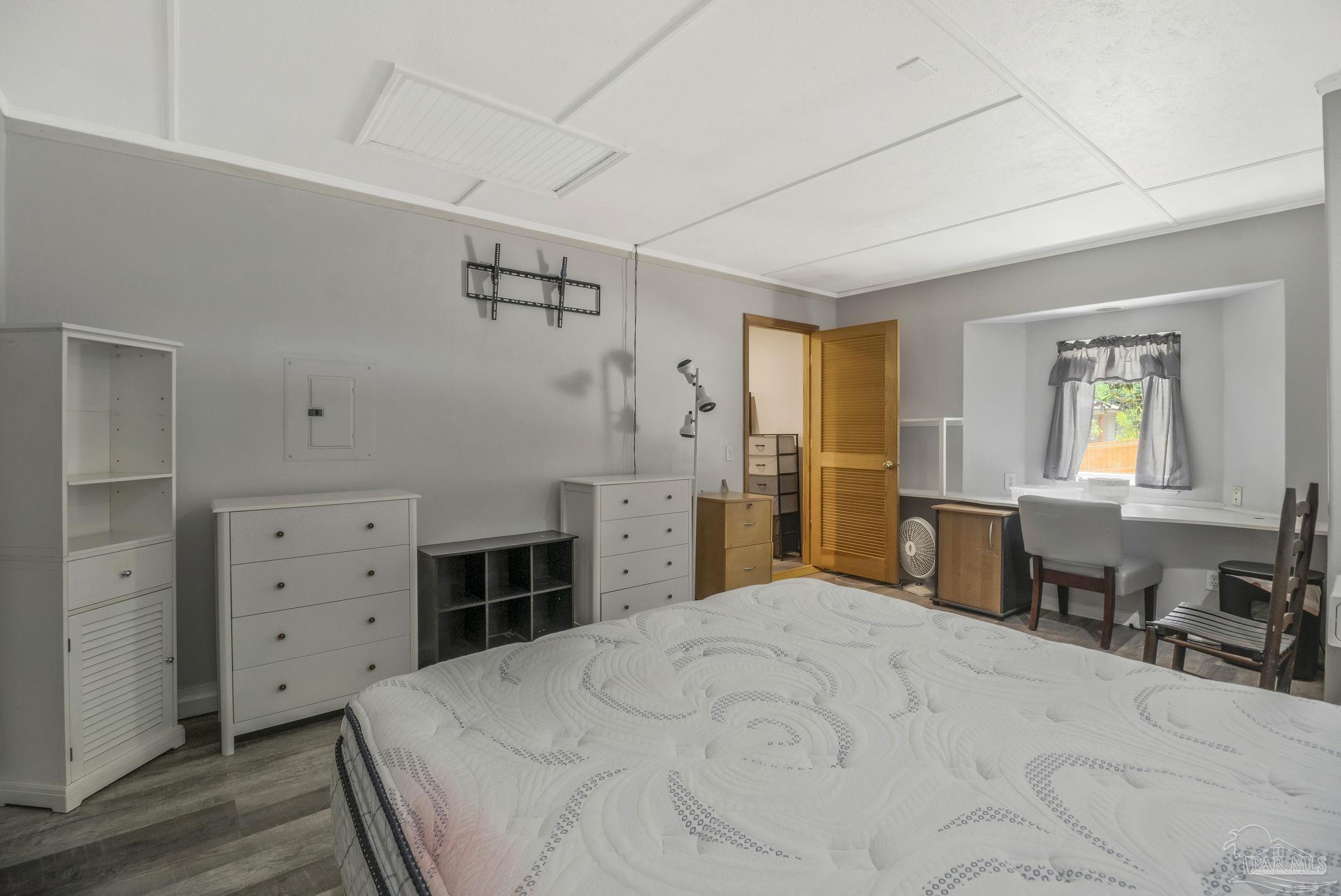 10290 West Lake Road Milton, FL 32583 - Photo 14 of 53 a bedroom with a bed and a window
