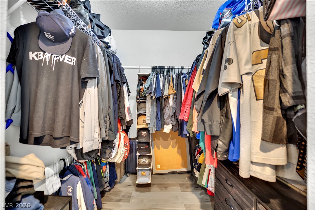 420 North Racetrack Road Henderson, NV 89015 - Photo 12 of 52 Walk-in closet offering ample hanging space and integrated storage for a streamlined wardrobe.