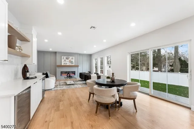 a living room with furniture a flat screen tv and a large window
