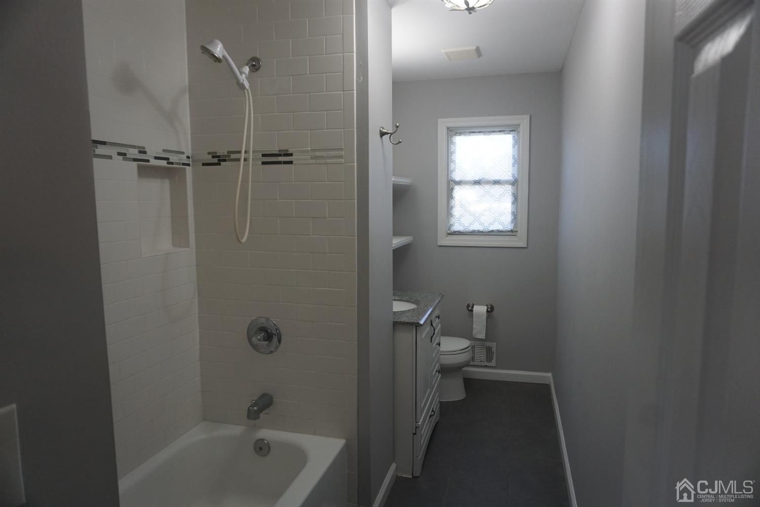 218 Princeton Road Old Bridge, NJ 08859 - Photo 14 of 24 a bathroom with a bathtub a toilet and a sink