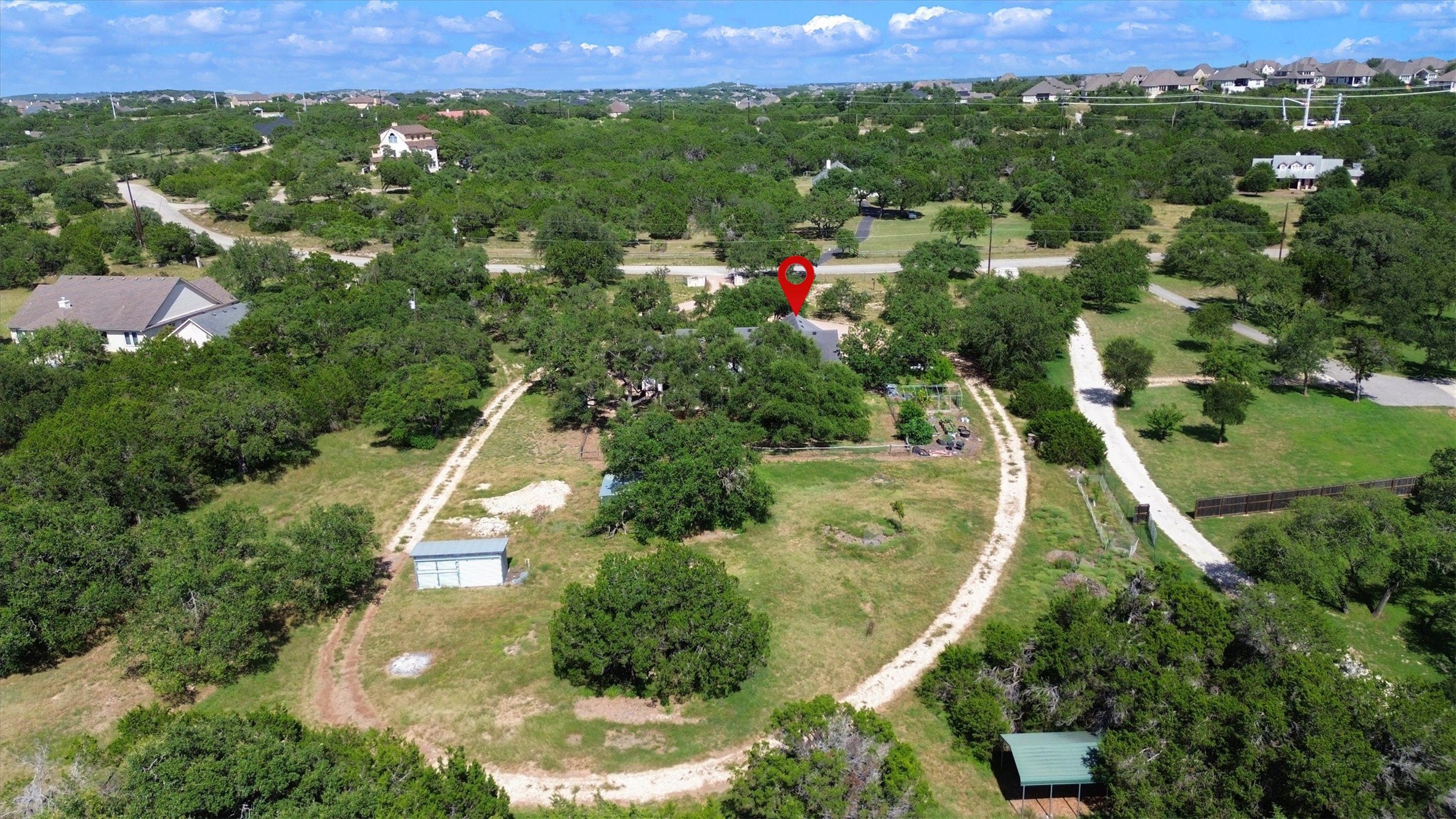 1120 Meadow Ridge Drive Austin, TX 78737 - Photo 36 of 40 An aerial perspective showcases a secluded home nestled amongst dense, verdant trees.