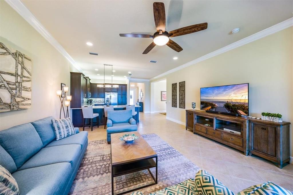 13474 Sumter Lane Naples, FL 34109 - Photo 11 of 25 a living room with furniture and a flat screen tv
