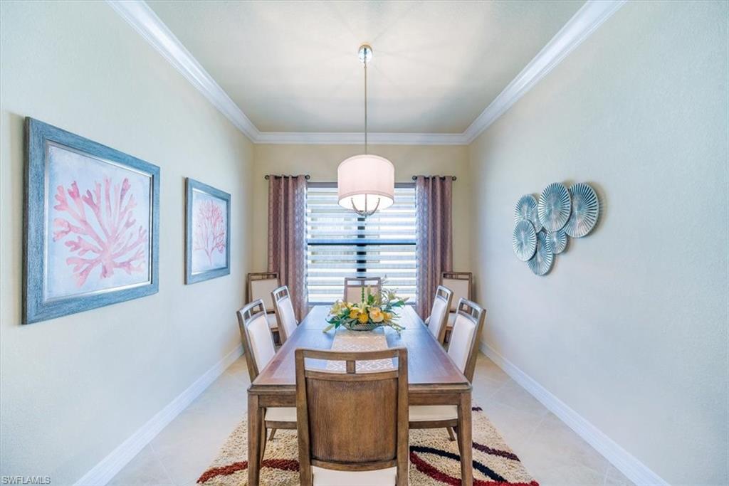 13474 Sumter Lane Naples, FL 34109 - Photo 16 of 25 a dining room with furniture a chandelier and window