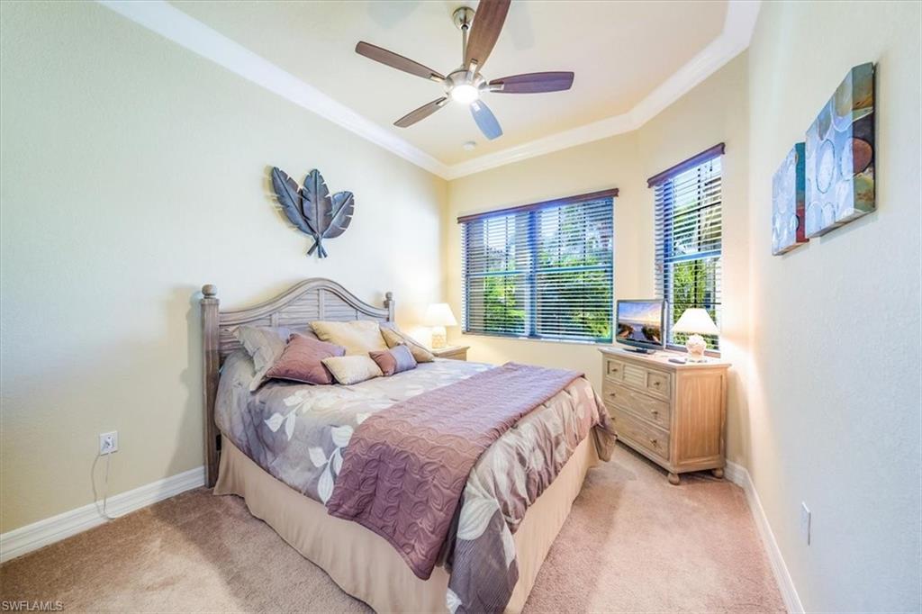 13474 Sumter Lane Naples, FL 34109 - Photo 20 of 25 a bedroom with a large bed and a window