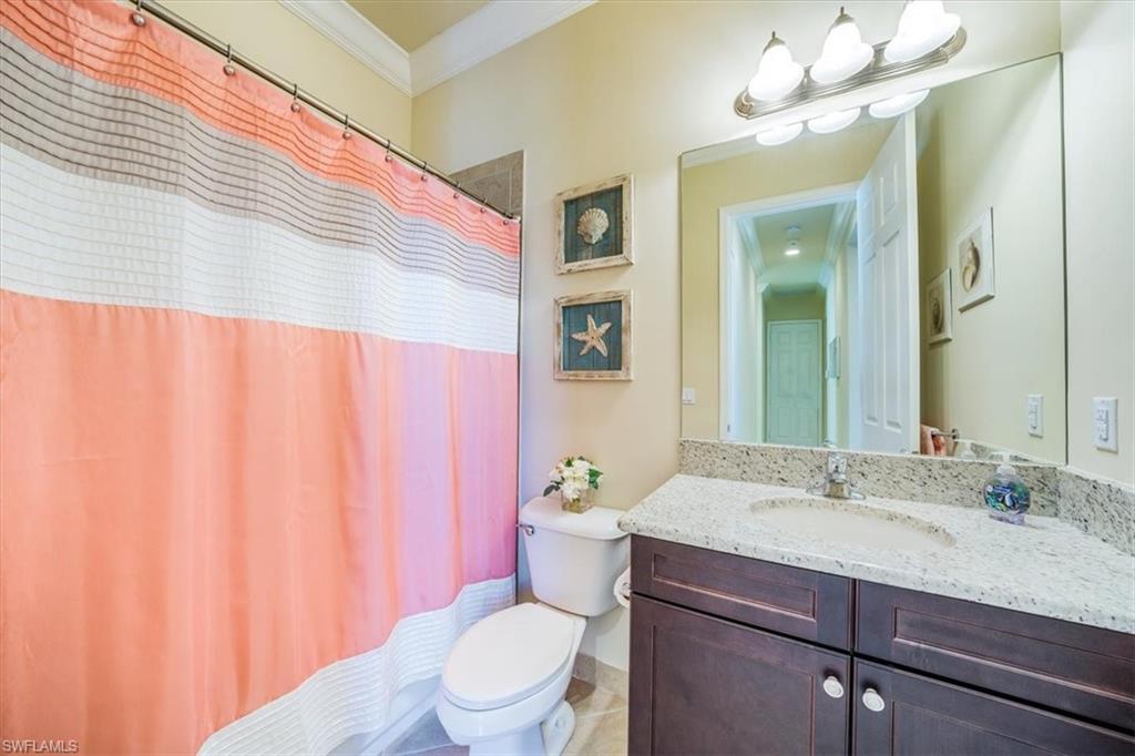 13474 Sumter Lane Naples, FL 34109 - Photo 21 of 25 a bathroom with a granite countertop sink a toilet and a mirror