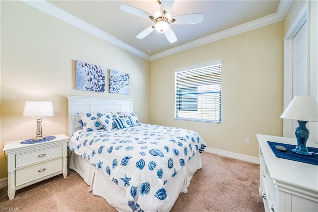 13474 Sumter Lane Naples, FL 34109 - Photo 22 of 25 a bedroom with a bed and a lamp on dresser