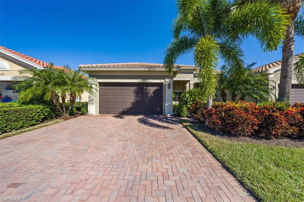 13474 Sumter Lane Naples, FL 34109 - Photo 3 of 25 a front view of a house with a garden