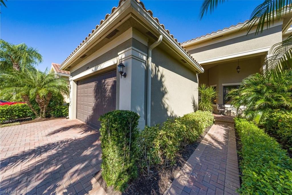 13474 Sumter Lane Naples, FL 34109 - Photo 4 of 25 a front view of a house with garden
