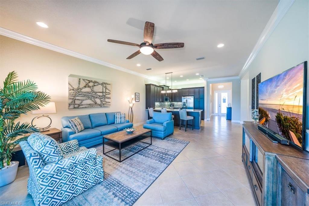 13474 Sumter Lane Naples, FL 34109 - Photo 7 of 25 a living room with furniture and a flat screen tv