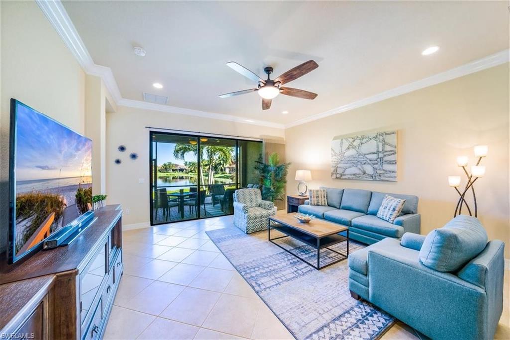 13474 Sumter Lane Naples, FL 34109 - Photo 8 of 25 a living room with furniture and a flat screen tv