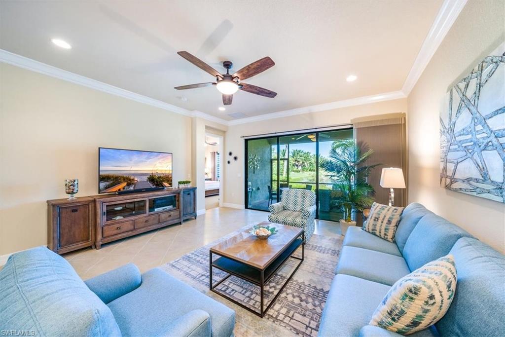 13474 Sumter Lane Naples, FL 34109 - Photo 9 of 25 a living room with furniture and a flat screen tv