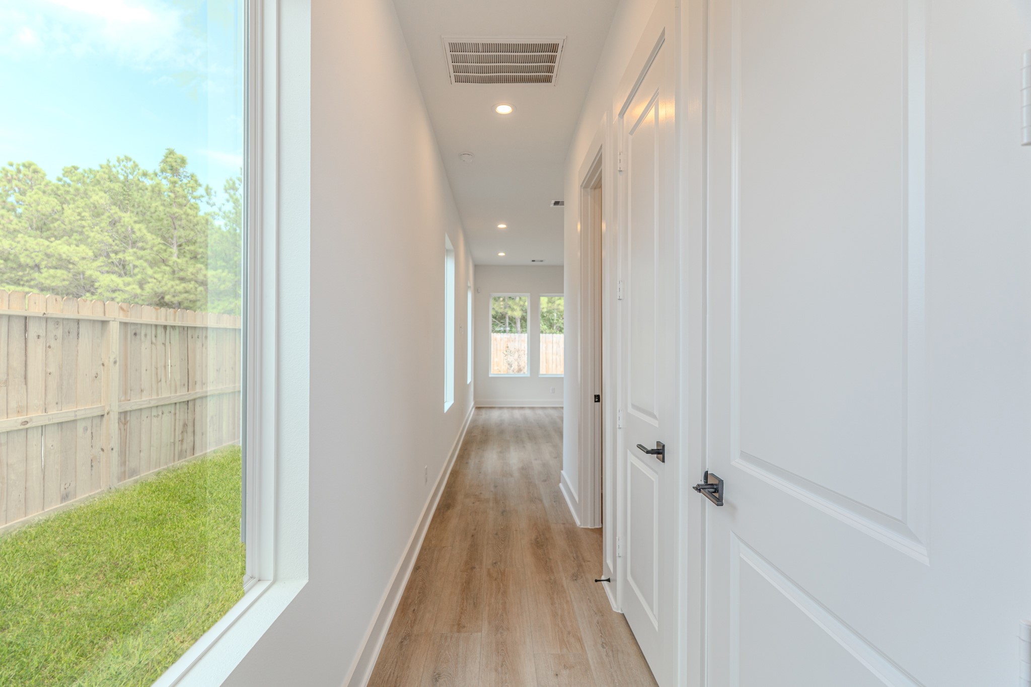 7628 Inwood Hls Lane Houston, TX 77088 - Photo 2 of 46 a view of a hallway with wooden floor and a bathroom