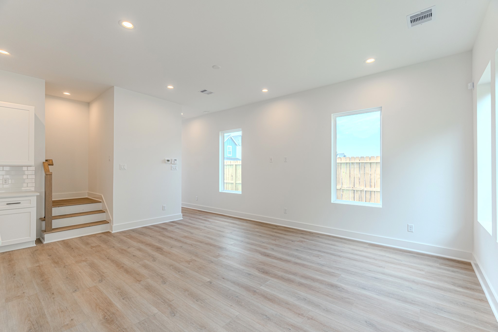 7628 Inwood Hls Lane Houston, TX 77088 - Photo 6 of 46 an empty room with wooden floor and windows
