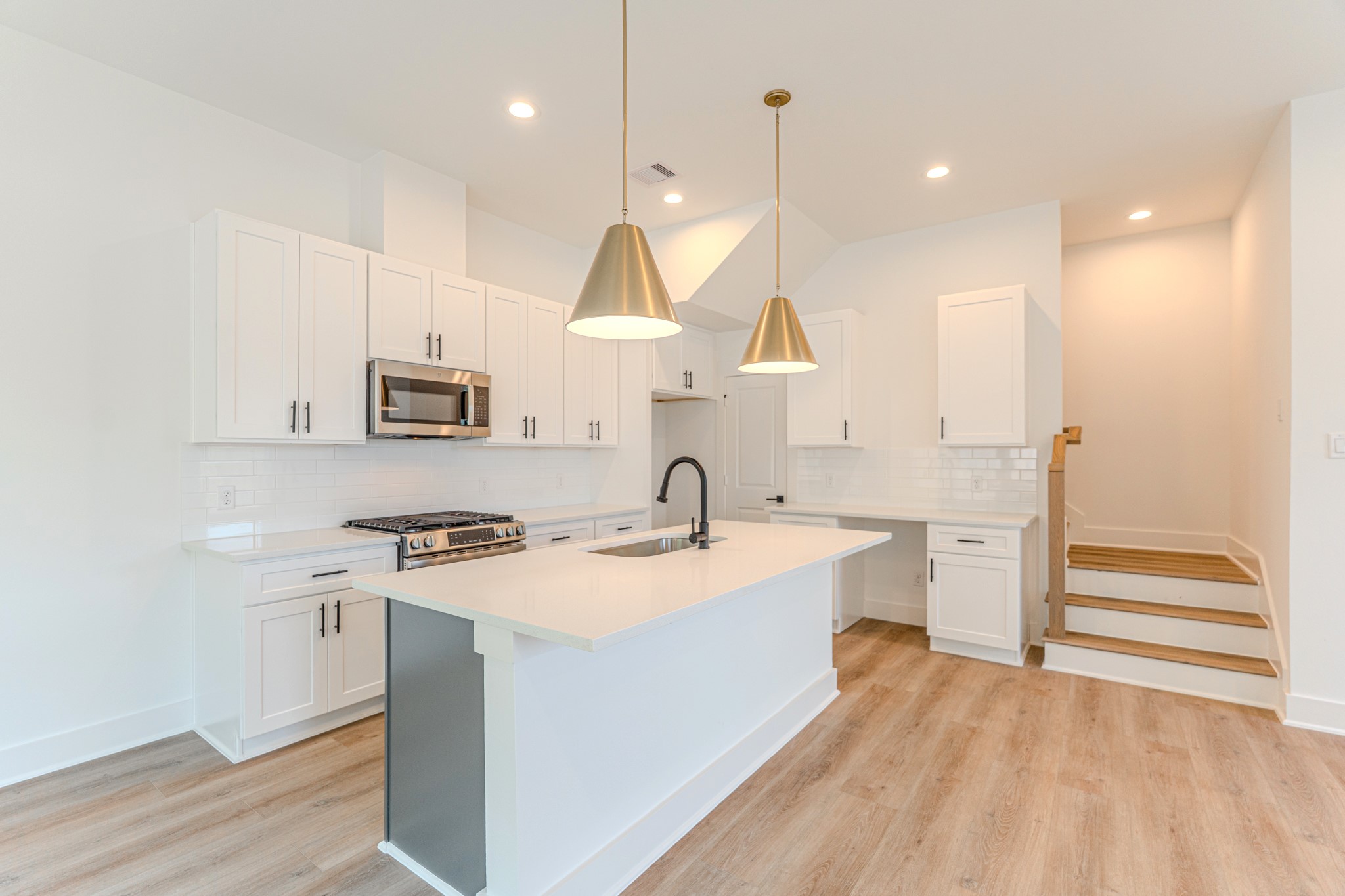 7628 Inwood Hls Lane Houston, TX 77088 - Photo 10 of 46 a kitchen with a sink a stove a refrigerator and cabinets