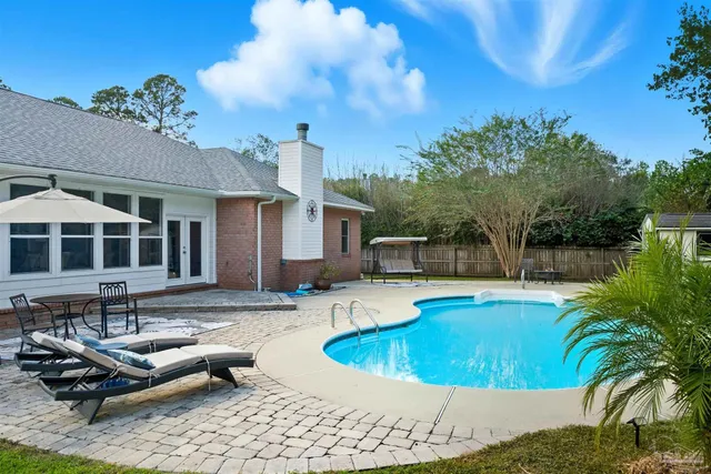 a living room with a bed furniture and a flat screen tv