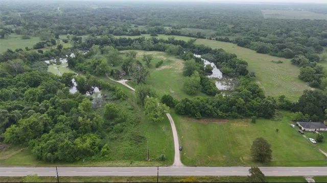 an aerial view of a houses with yard