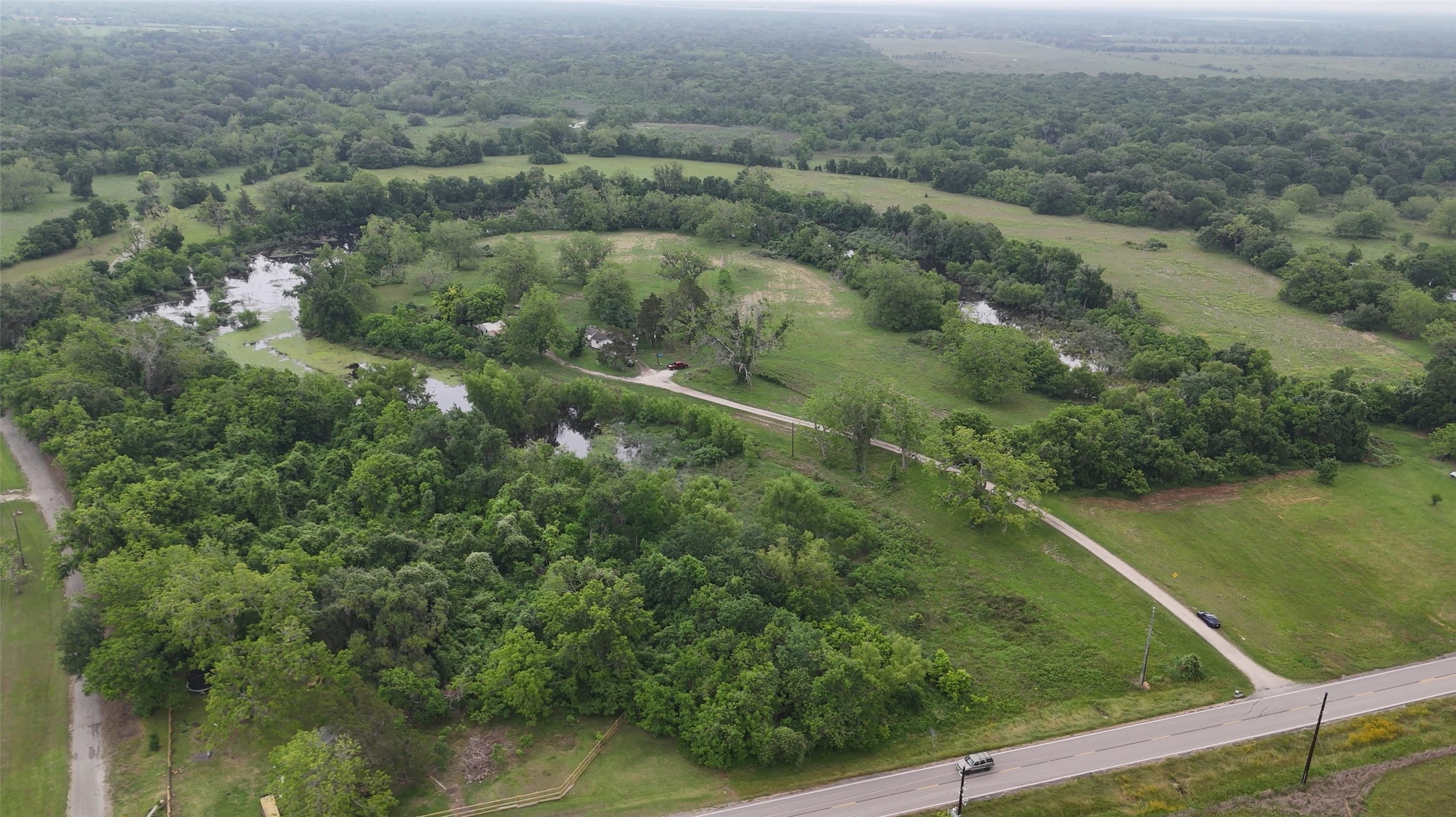 2627 FM 524 Road Sweeny, TX 77480 - Photo 4 of 9 an aerial view of residential houses with outdoor space and trees