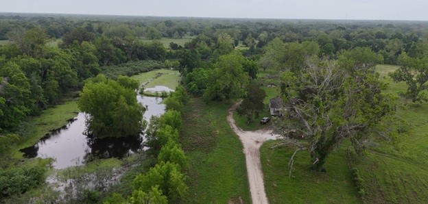 2627 FM 524 Road Sweeny, TX 77480 - Photo 7 of 9 an aerial view of residential house with outdoor space and trees all around