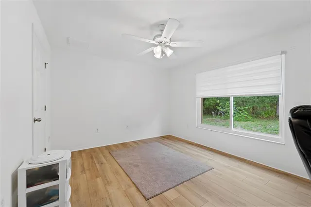 a view of a livingroom with a ceiling fan and a window