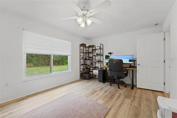 a view of a workspace with furniture and a window