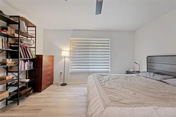 a bedroom with a bed and a book shelf