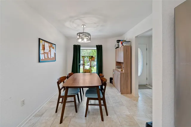 a view of a dining room with furniture and window