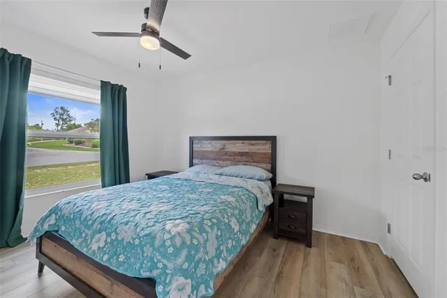 a bed sitting in a bedroom next to a window