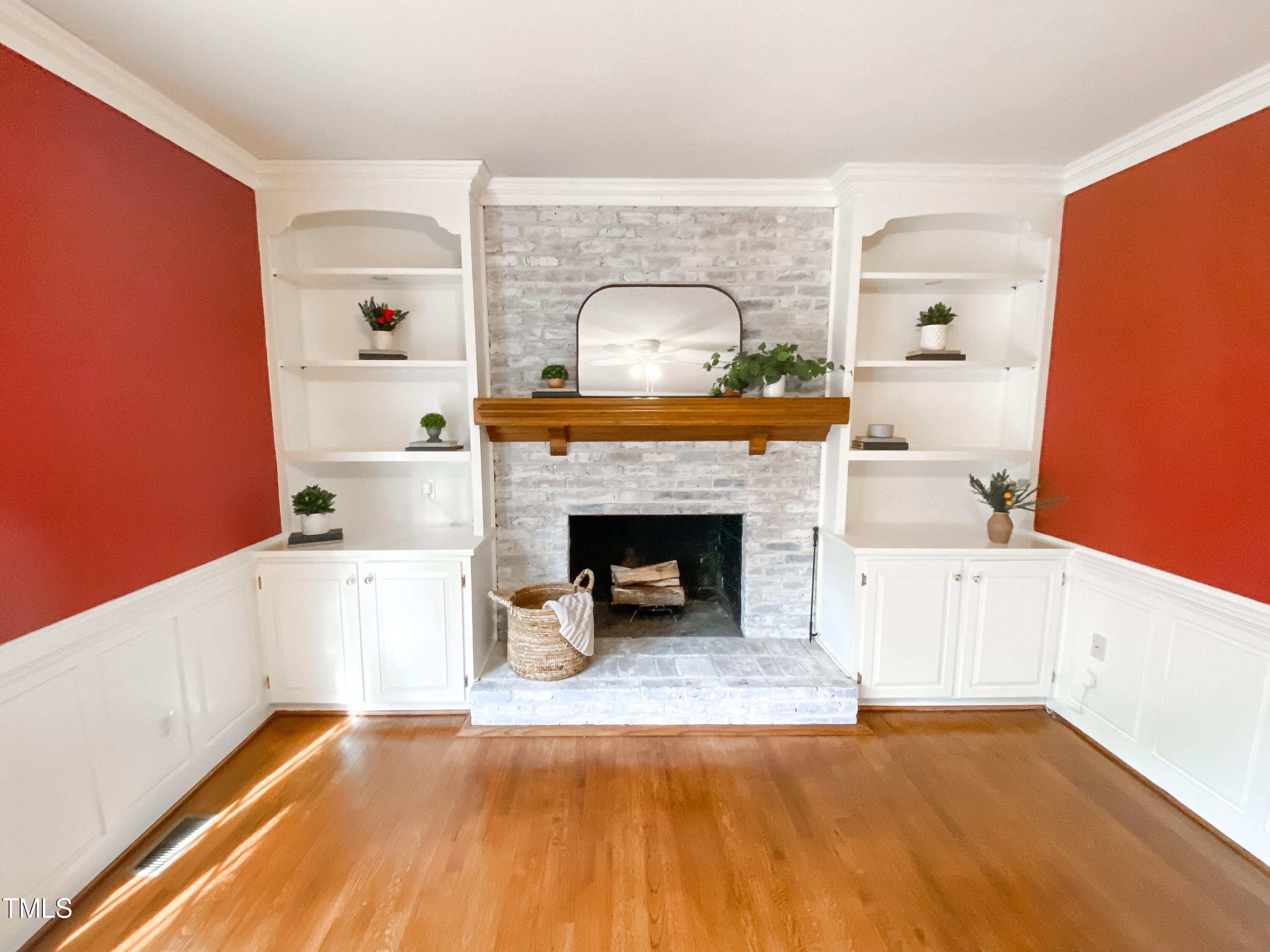 7905 Farnham Court Raleigh, NC 27615 - Photo 13 of 28 a living room with a fireplace and a wooden floor