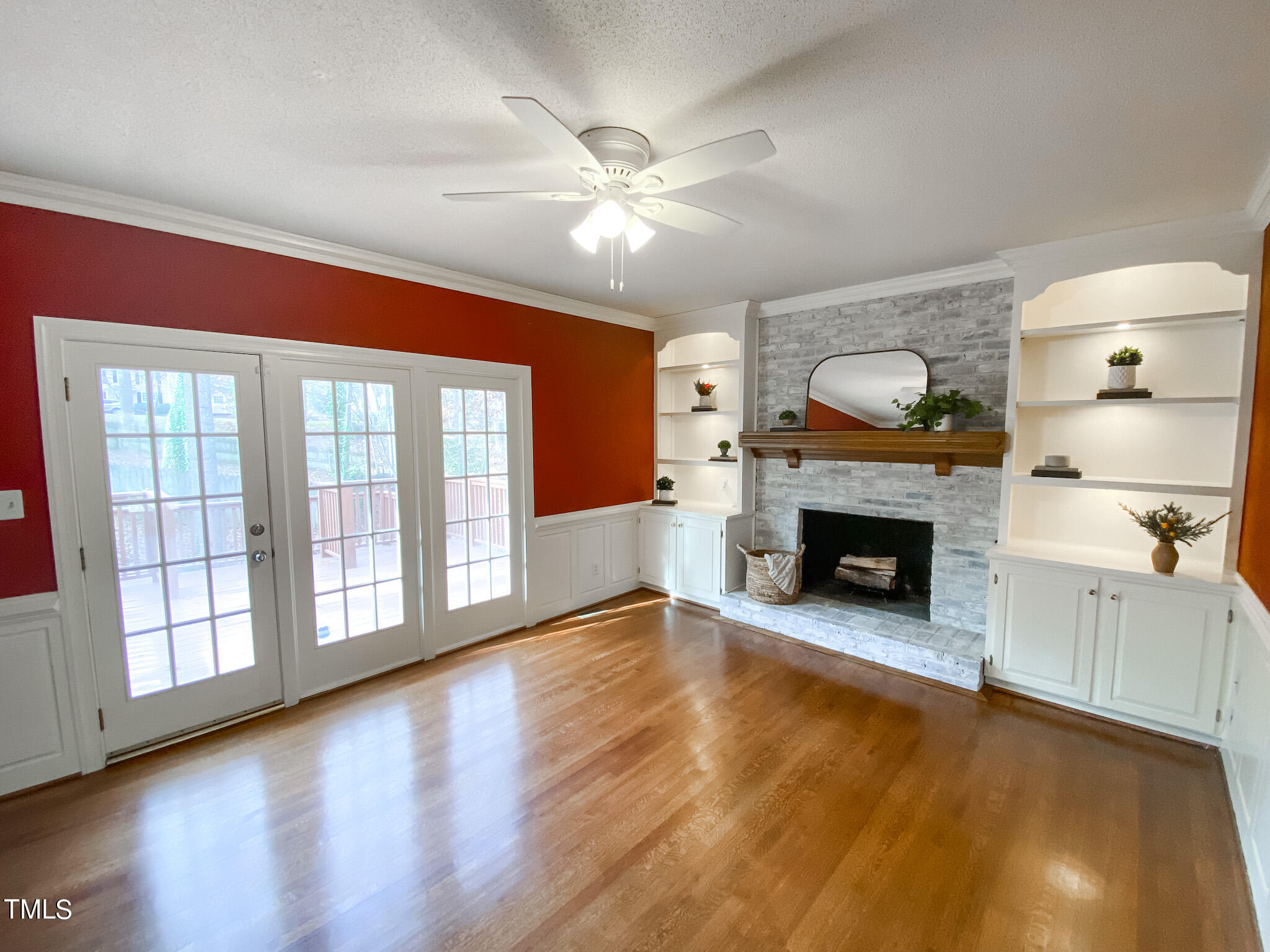 7905 Farnham Court Raleigh, NC 27615 - Photo 15 of 28 a view of an empty room with wooden floor fireplace and a window