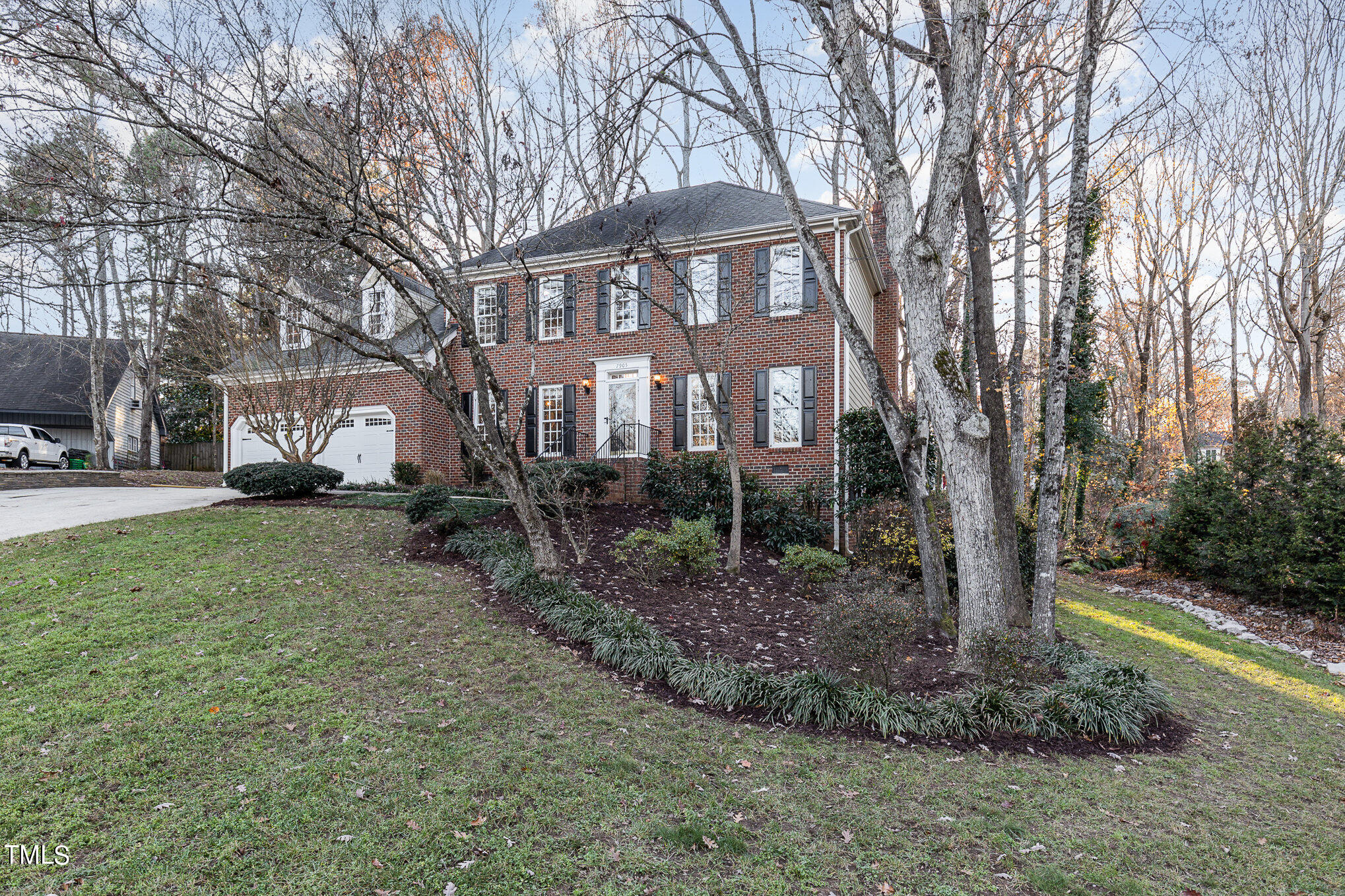 7905 Farnham Court Raleigh, NC 27615 - Photo 4 of 28 a view of a white house next to a yard with a tree