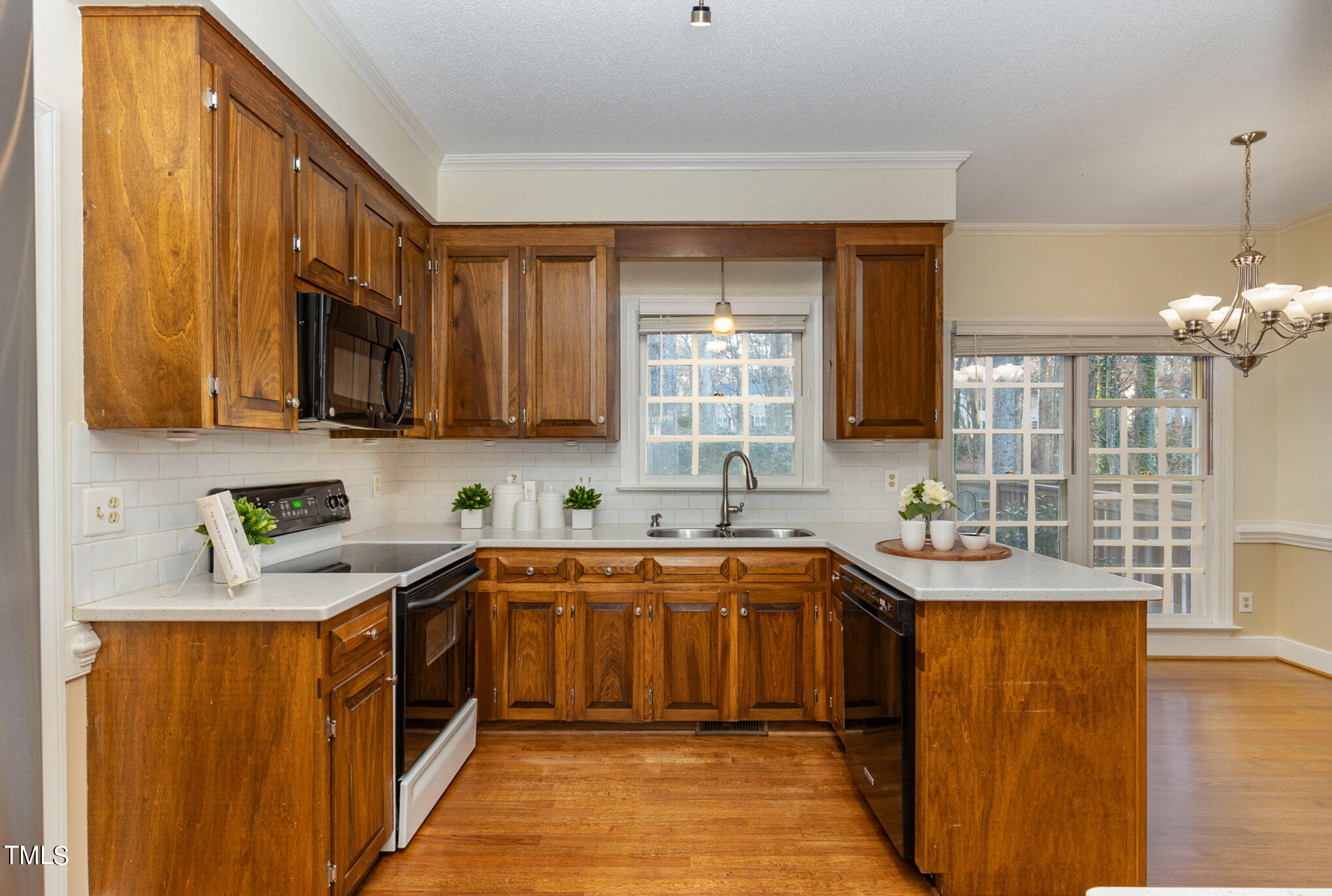 7905 Farnham Court Raleigh, NC 27615 - Photo 7 of 28 a kitchen with stainless steel appliances granite countertop a sink stove and refrigerator