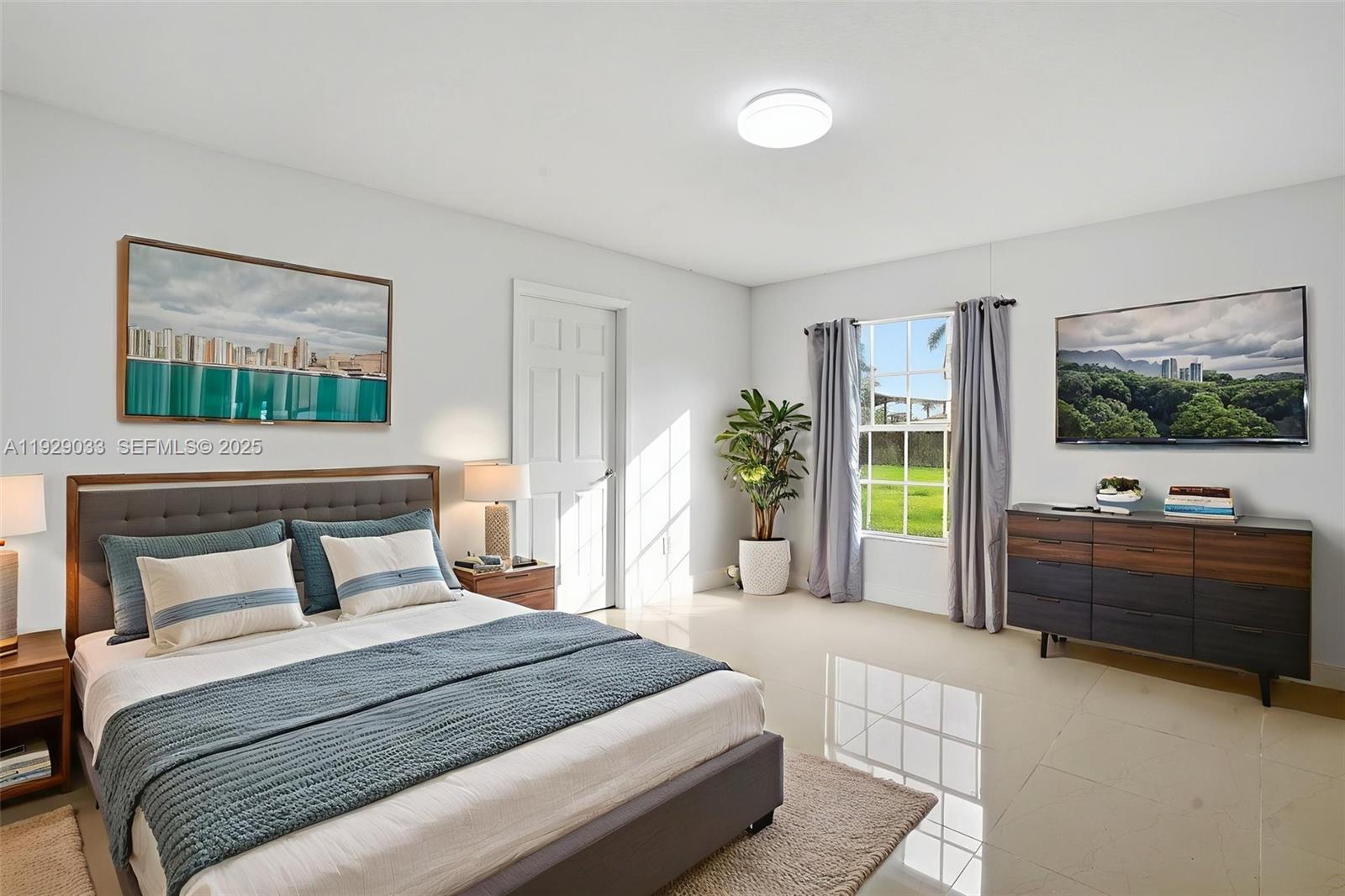 21080 Southwest 242nd Street Homestead, FL 33031 - Photo 14 of 37 a bedroom with a large bed and windows