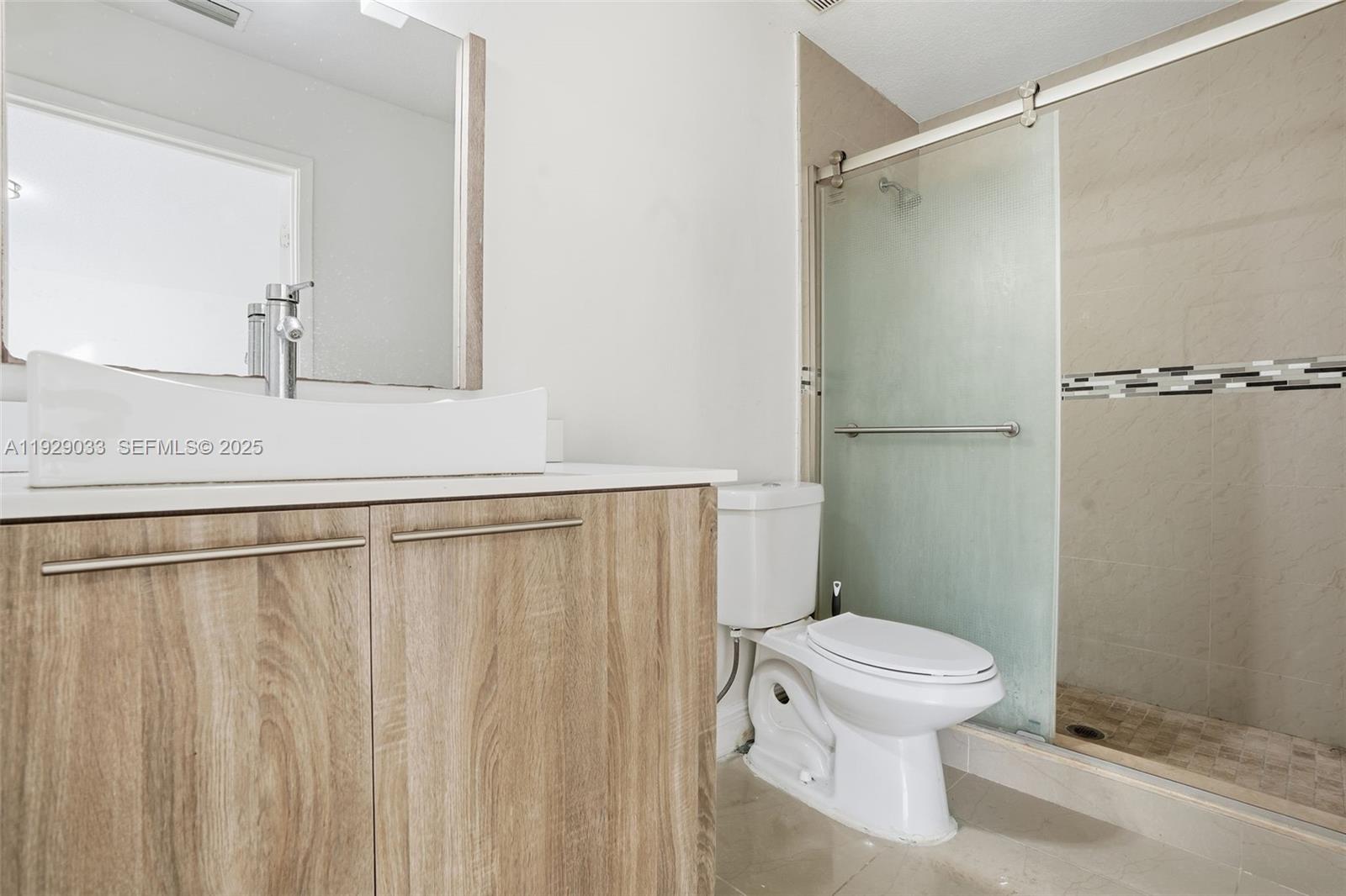21080 Southwest 242nd Street Homestead, FL 33031 - Photo 16 of 37 a white toilet sitting next to a bathroom sink