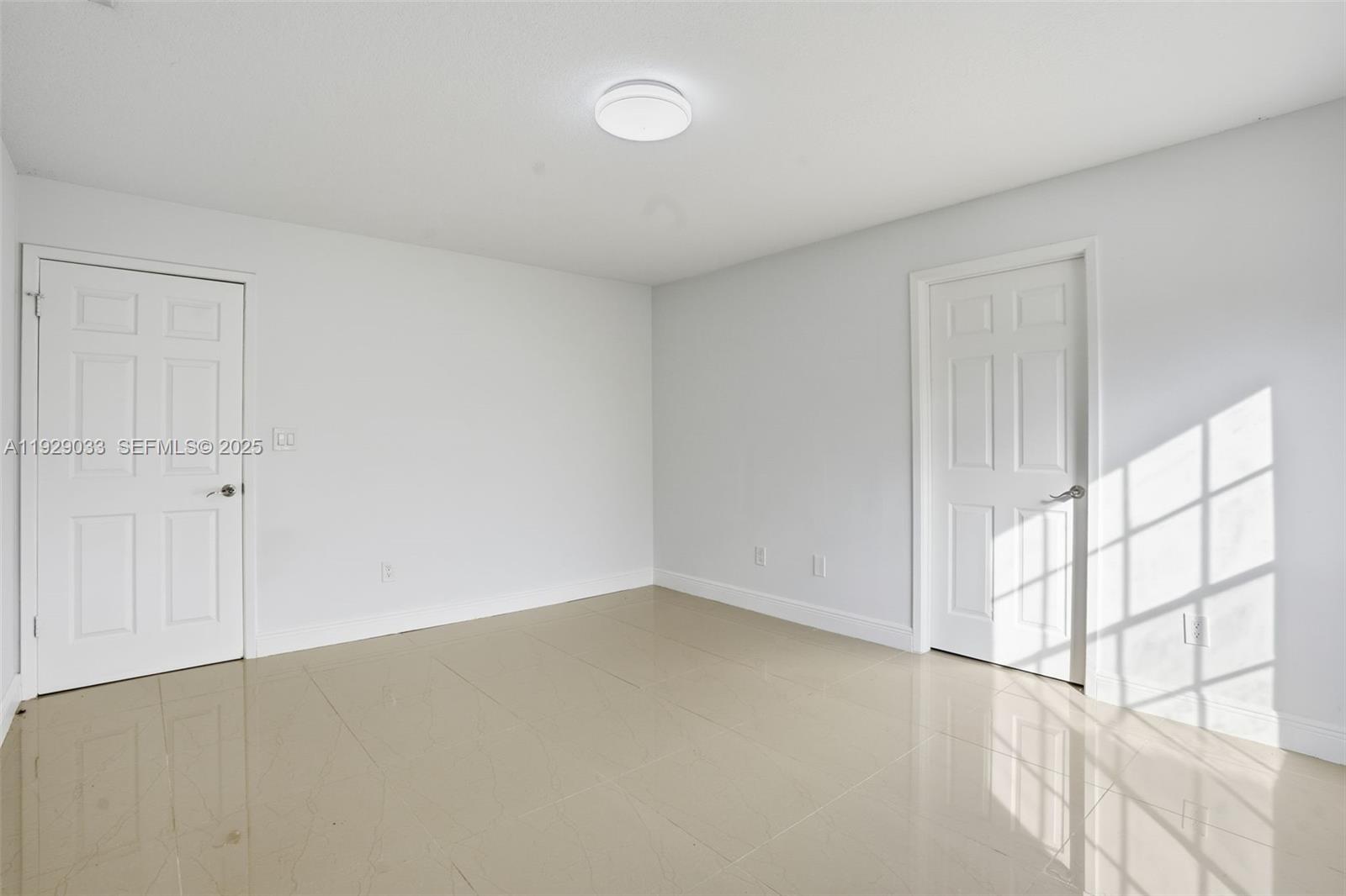 21080 Southwest 242nd Street Homestead, FL 33031 - Photo 18 of 37 wooden floor in an empty room with a window