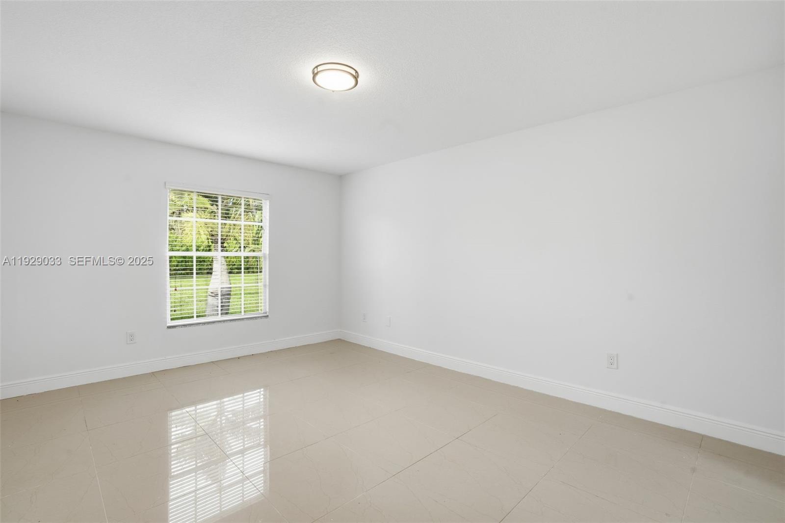 21080 Southwest 242nd Street Homestead, FL 33031 - Photo 19 of 37 an empty room with a window
