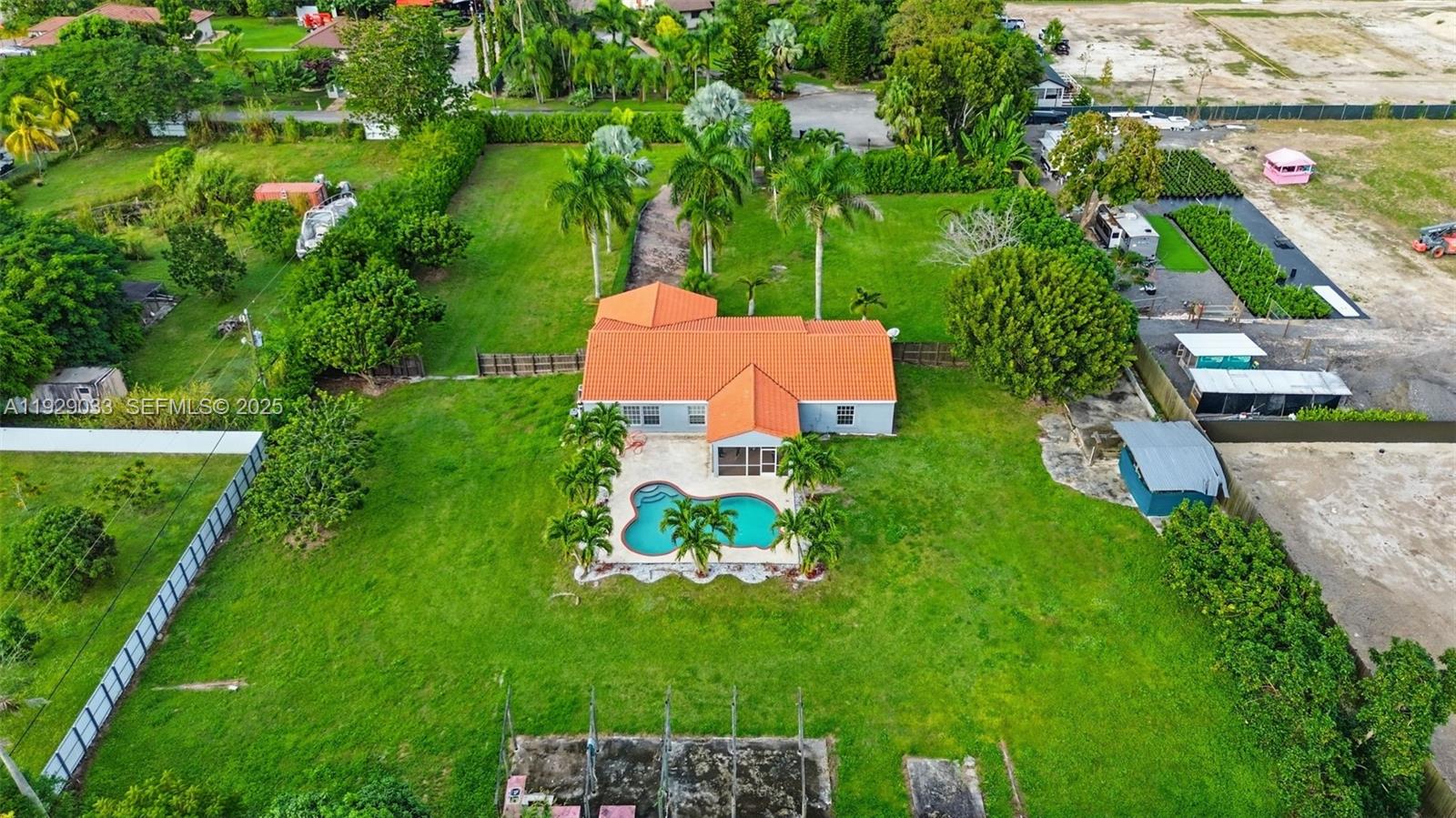 21080 Southwest 242nd Street Homestead, FL 33031 - Photo 2 of 37 an aerial view of a house with pool yard and outdoor seating