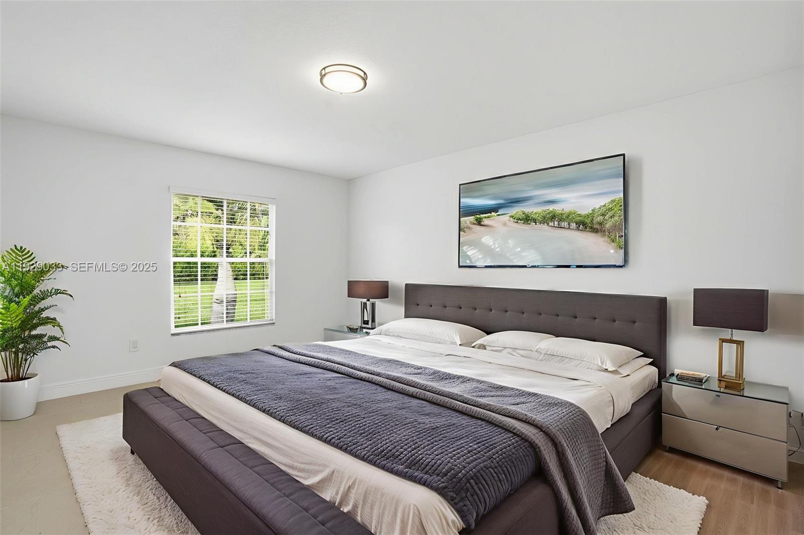 21080 Southwest 242nd Street Homestead, FL 33031 - Photo 22 of 37 a bedroom with a bed and a potted plant
