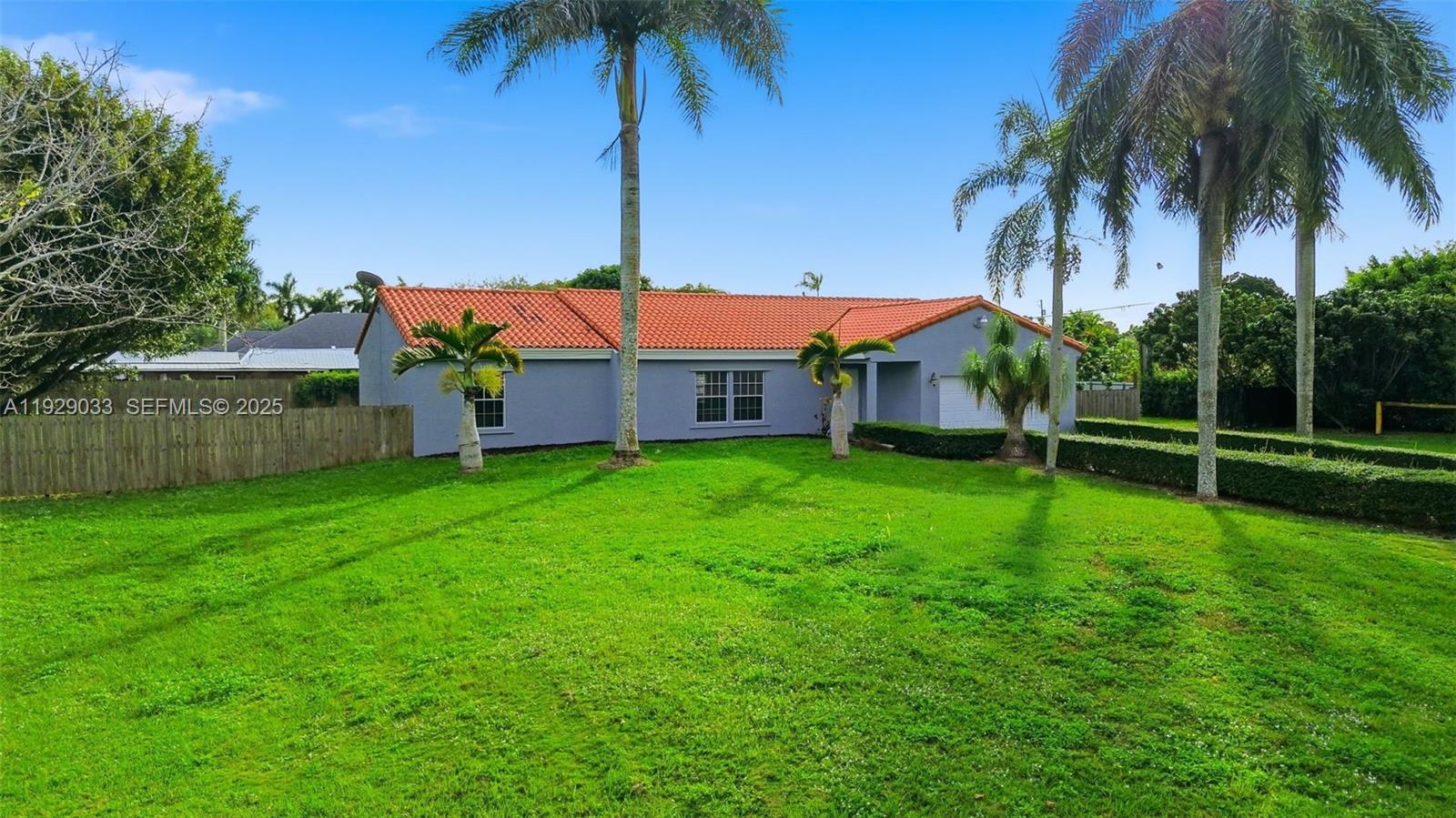 21080 Southwest 242nd Street Homestead, FL 33031 - Photo 5 of 37 a view of a house with a backyard and a palm tree
