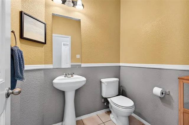 a bathroom with a sink mirror and toilet