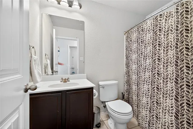 a bathroom with a sink toilet and a mirror