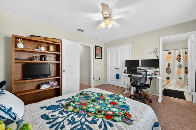 a bedroom with a bed and flat screen tv