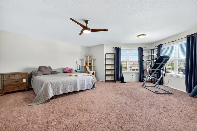 a spacious bedroom with a bed closet and a window