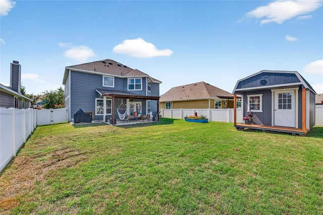 a view of a house with a yard and sitting area
